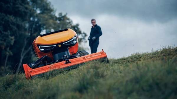Editorial illustration for Selecting the Best Robotic Lawn Mower for Large Yards and Steep Slopes